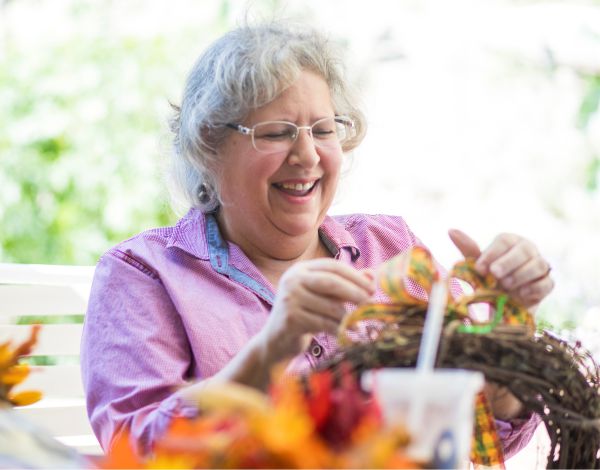 Projekttrainer (m/w/d) im Bereich Natur, Kreativität und psychosoziale Gesundheit in Leverkusen Eine ältere Dame dekoriert einen Kranz